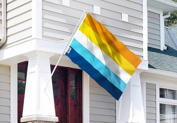 The Aroace flag displayed on the front of a house, symbolizing support and pride for the aroace and LGBTQ+ community.