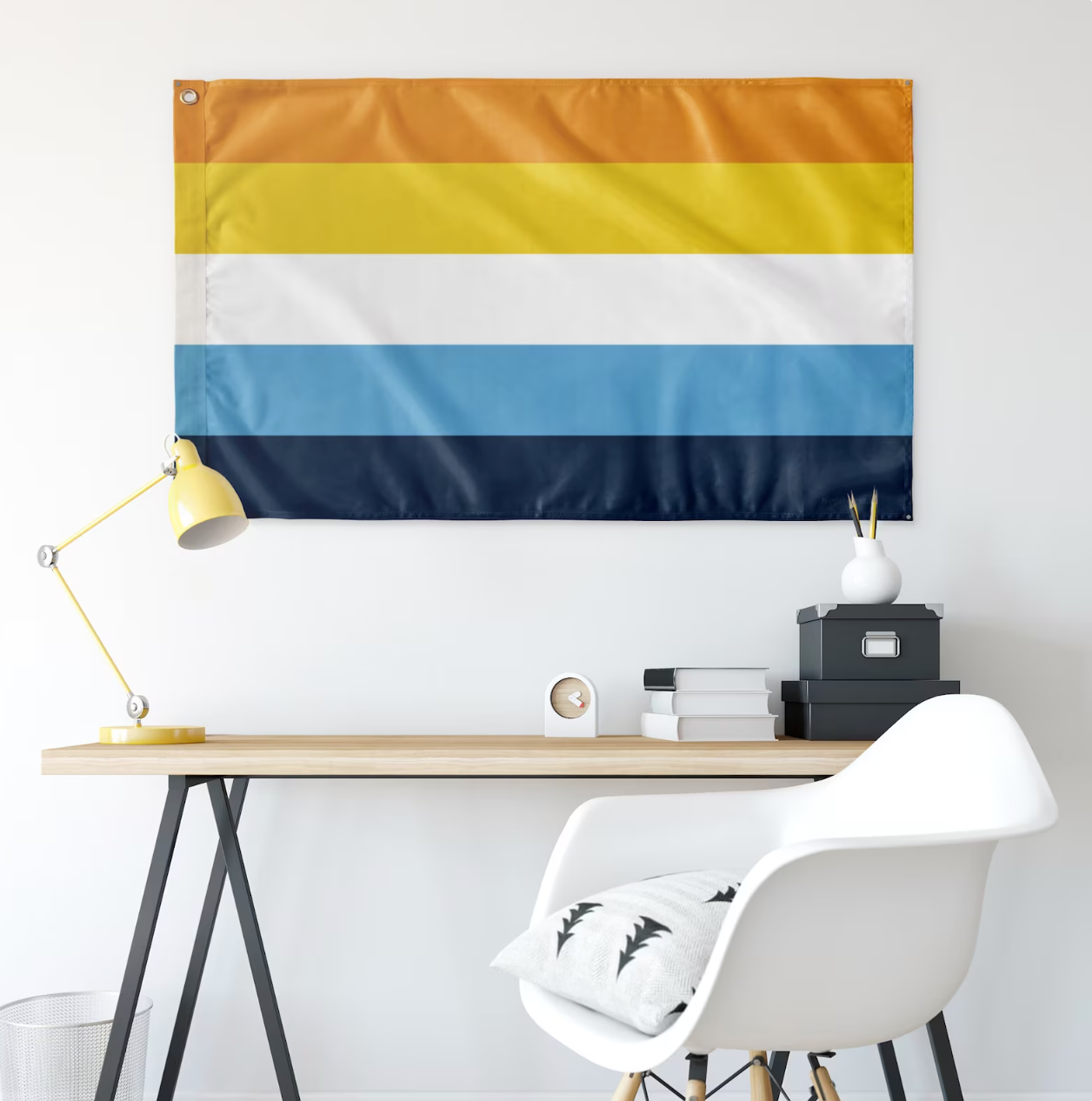 The Aroace Flag hanging above a desk at home, adding a touch of pride and support for the aroace community in a personal workspace